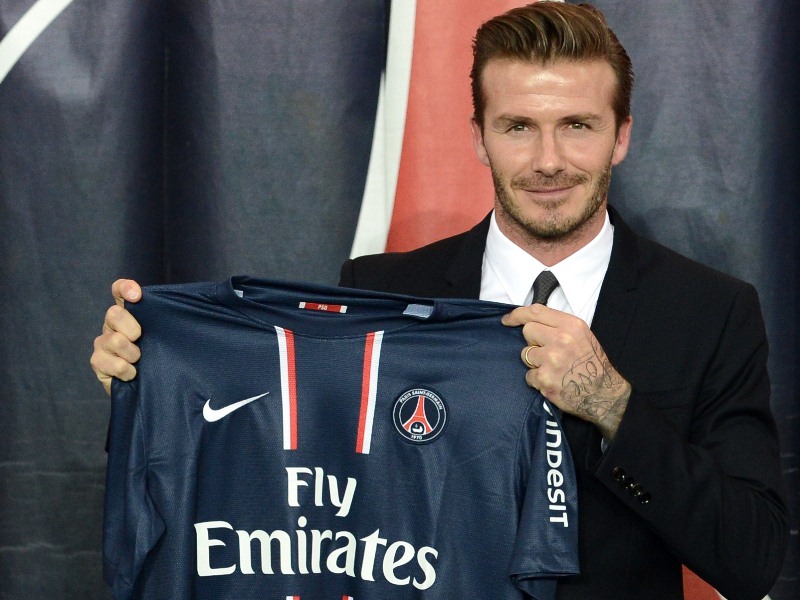 British football player David Beckham poses presenting his new jersey after a press conference on January 31, 2013 at the Parc des Princes stadium in Paris. Beckham signed a five-month deal with the French Ligue 1 football club Paris Saint Germain until the end of June.      AFP PHOTO / FRANCK FIFE